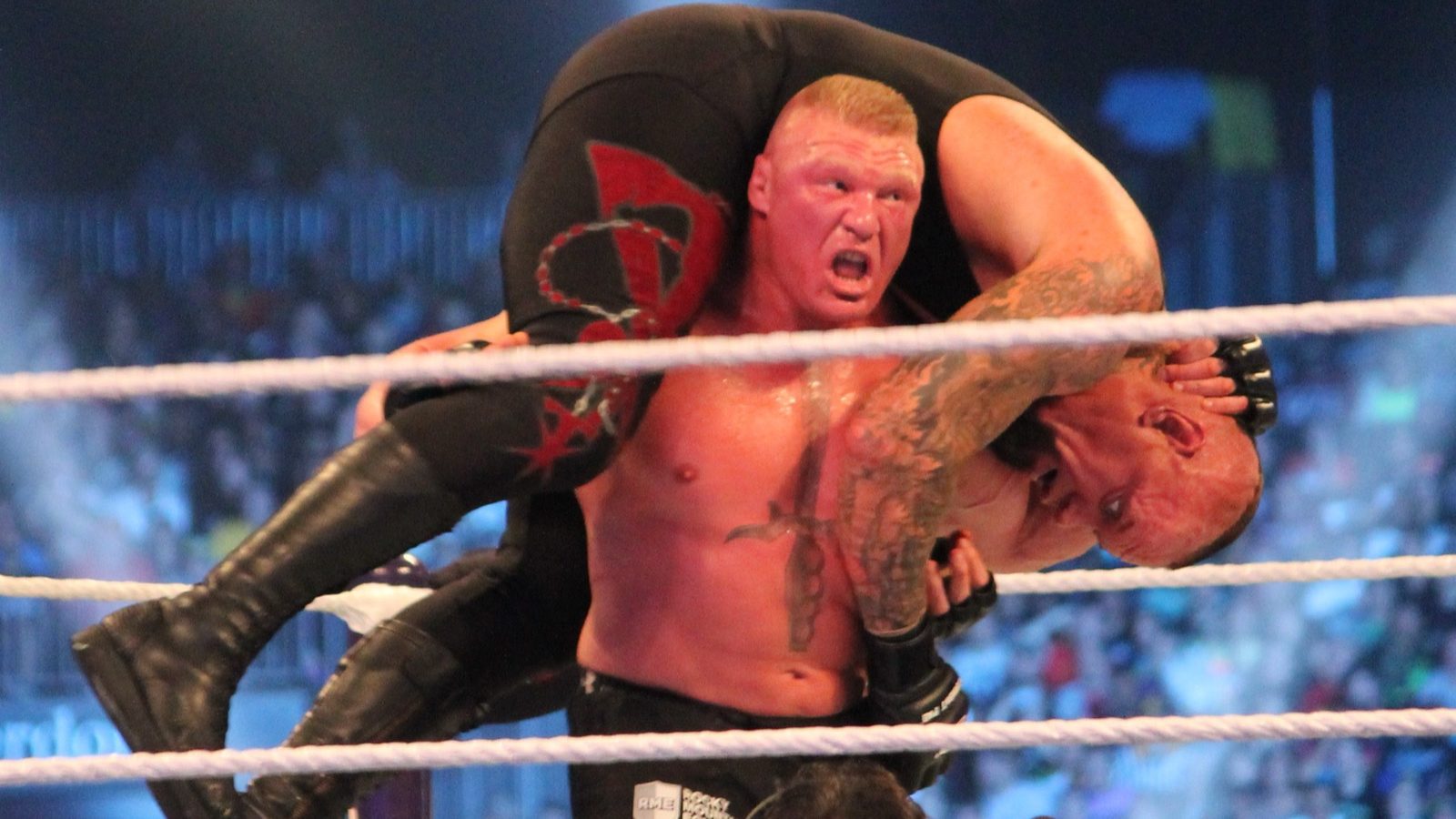 Brock Lesnar lifts the Undertaker for an F-5 at WrestleMania XXX in the Mercedes-Benz Superdome, New Orleans, April 6, 2014