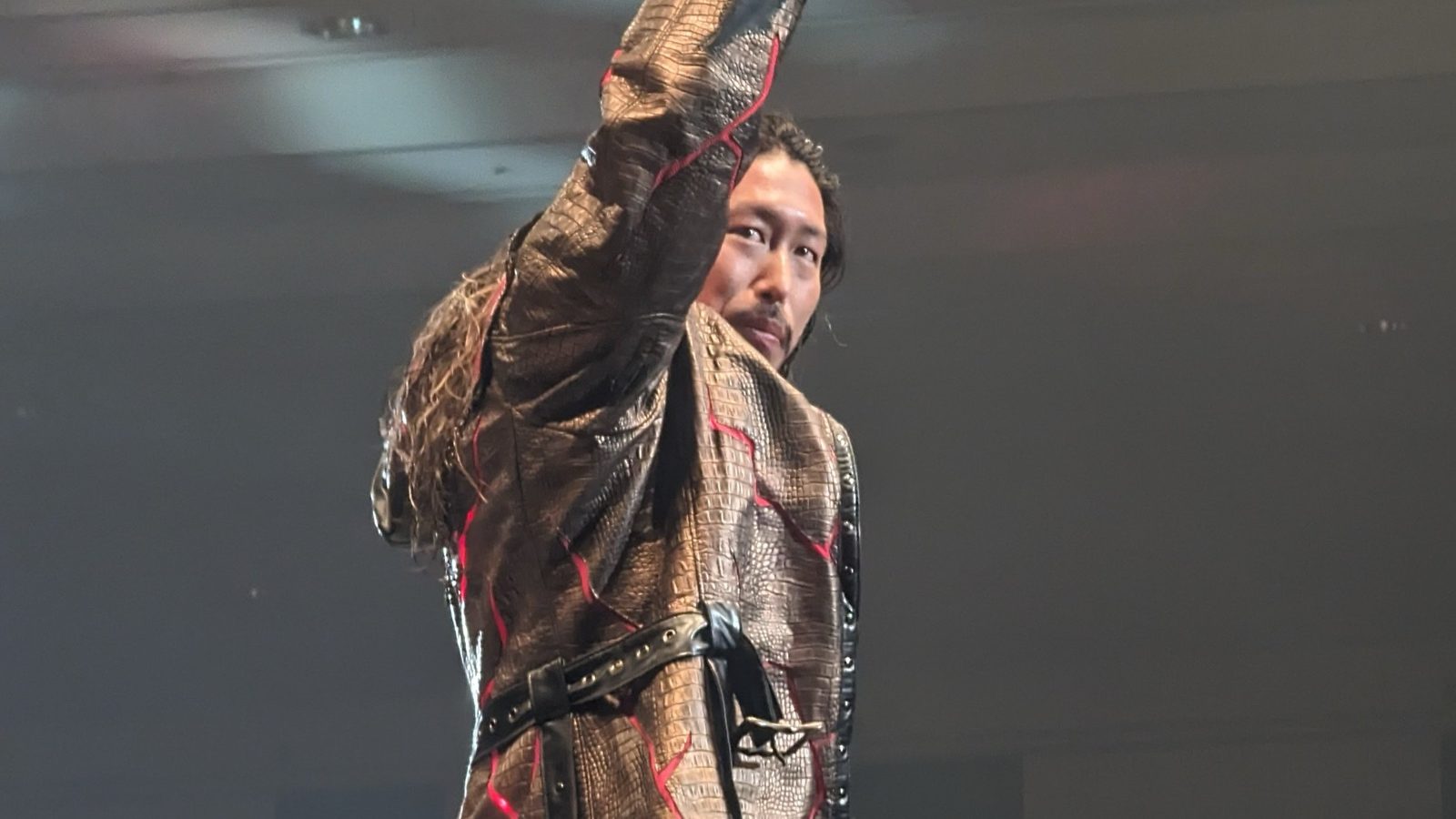 Yota Tsuji raising his fist on the ring ropes at an NJPW show in Osaka, November 2023