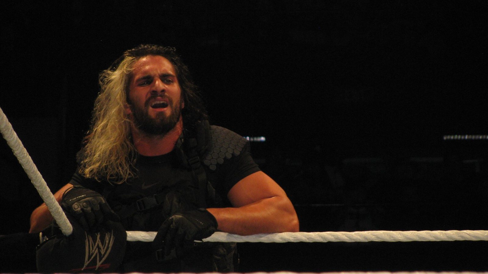 Seth Rollins leaning on the ring ropes at a WWE house show in Adelaide, Australia, in July 2013